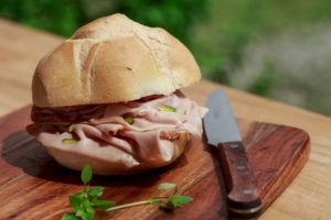 A mortadella with pistachio sandwich.